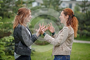 Women face to face having conversation gesticulate with hands