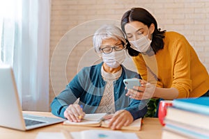 Women in facemasks are using laptop