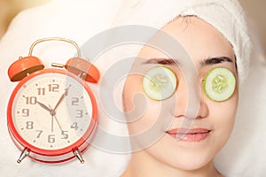 Women facial treatment in spa with time clock. Beauty times reverse to healthy skin to baby face anti aging cosmetic concept