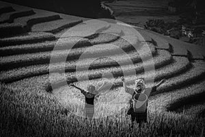 Women farmer and daughter raising armÃÂ ÃÂ¸ÃÂ¡ on Rice fields terrace