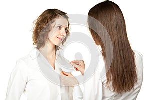 Women fastening badge at business conference