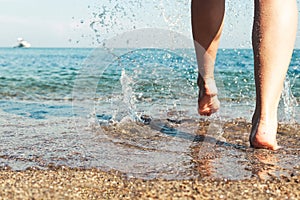 Women foot splashing on the beach