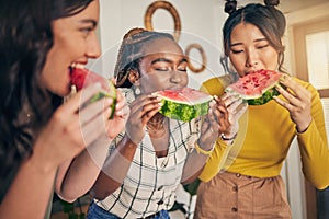 Women, friends and eating watermelon in home for bonding, nutrition and happy lunch together. Healthy diet fruit
