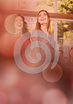 Women friends having fun celebration party with sparkling lights bokeh transition