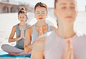 Women friends meditation while training yoga exercise on the beach. Young zen spiritual female athlete workout outdoor