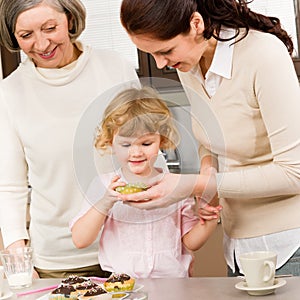 Women generations around cupcake cookies