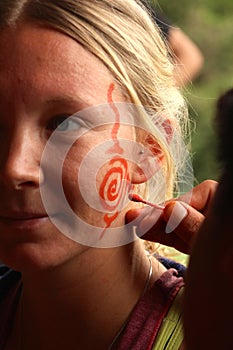 Women getting a traditional face paint