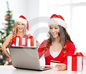 Women with gift, laptop computer and credit card