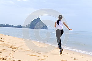 Women good shape morning running on beach