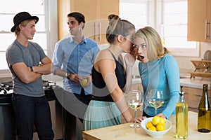 Women gossiping about men at a party spreading rumors and secrets telling reputation about past relationships