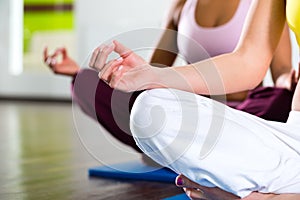 Women in the gym doing yoga exercise for fitness