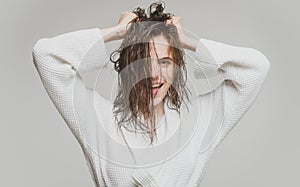 Women hair care. Young brunette woman with nourished long hair, studio shot.