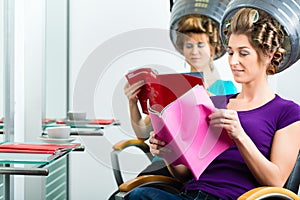 Women at the hairdresser with hair dryer