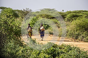 Women of the Hamer tribe walking