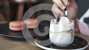 women hand eating a jar of cheese cakes parfait