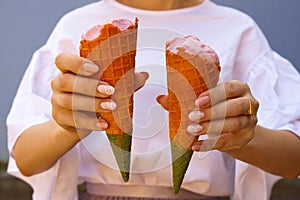 women hand holding ice cream cone. rainbow ice cream cone - hands holdling ice cream cones at hot summer day