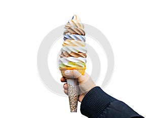 A women hand holding mixed colorful rainbow tasty ice cream soft cream cone isolated on white background, clipping path