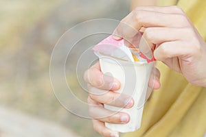 Women hand opening the fruit salad soy milk jelly, yogurt, dessert, healthy, sweet, yummy