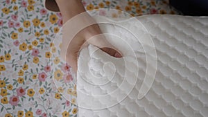 women hand on Orthopedic pillow on a bed