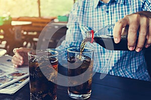 Women hand pour or fill soda drink in glass