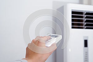 Women hand is regulating the heater/air condition temperature photo