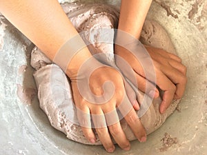 Women hand thresh flour in enameled bowl.