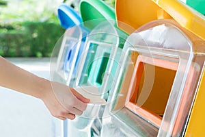 Women hand throwing away the garbage to the bin/trash, sorting waste/garbage before drop to the bin