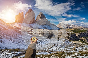 Women hand using a compass in the mountains, travel concept. Han