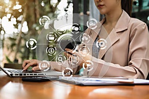 Women hand working with smart phone and laptop computer, tablet with virtual icon diagram in the morning