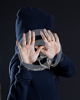 Women in handcuffs avoiding photographer