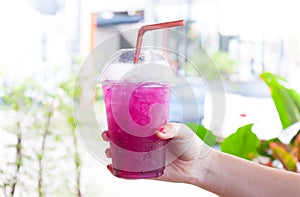 Women Handle holding Ice water italian soda purple in plastic cup