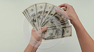 women hands count dollar bills spreading out a fan in front of them