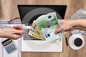 Women hands exchanging euro banknotes, close up