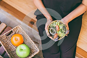 Woman hands holding and eating healthy salad for breakfast in the morning,Clean eating and dieting