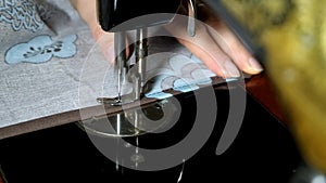 Women hands of seamstress using vintage sewing machine