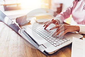 Women hands typing on the keyboard Work at home.