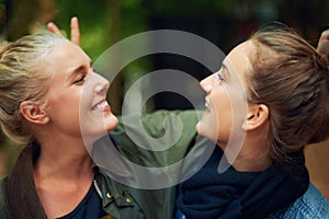 Women, happy and smile in forest for connection, bonding and unity outdoors together in nature. Female friends, gaze and