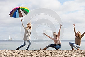 Women having fun with umbrella