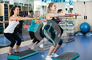 Women having group aerobic train