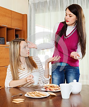 Women having squabble at table photo