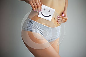 Women Health. Closeup Of Healthy Female With Beautiful Fit Slim Body In White Panties Holding White Card With Happy