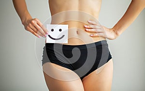 Women Health. Closeup Of Healthy Female With Beautiful Fit Slim Body In White Panties Holding White Card With Happy