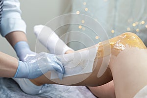 Women Healthcare Concept. Beautician Doing Depilation With Hot Wax On Woman`s Leg