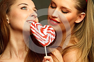 women with heart shaped lollipop