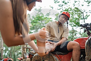 women help the man to reduce his injured foot by massaging it