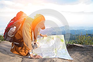 Women hiker with backpack checks map