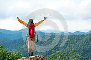 Women hiker or traveler with backpack adventure feeling victorious facing on the mountain, outdoor for education nature on vacatio