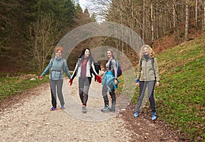 Women hikers with backpacks in the mountains