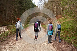 Women hikers with backpacks in the mountains