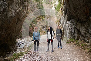 Women hikers with backpacks in the mountains